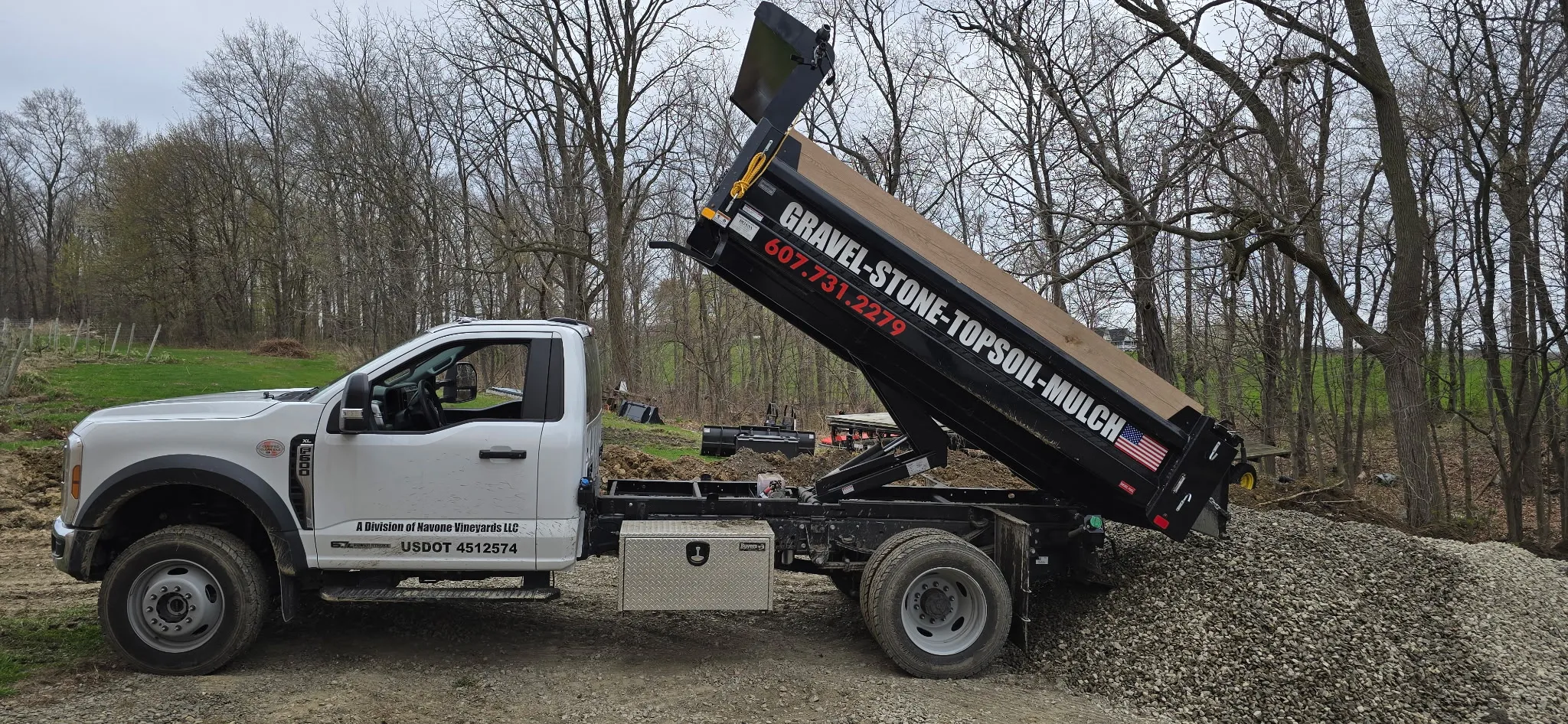 D.O.G.S delivery truck unloading a load of gravel